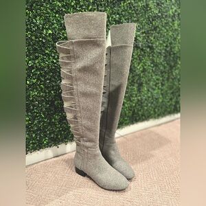 Nine West knee-high gray boots with cut out details along back of shaft.